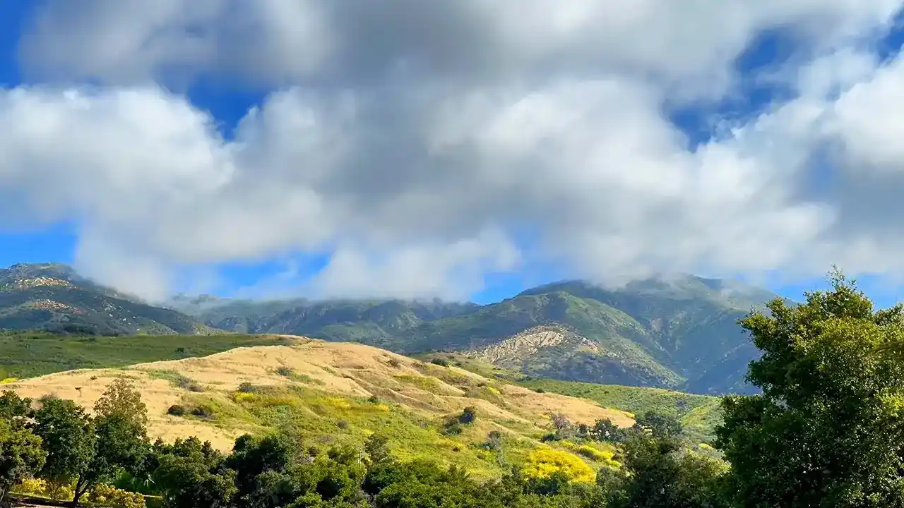 Mountains and fluffy clouds